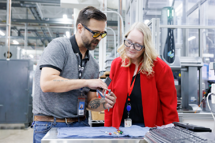 Melissa Kacena works with a man in Warsaw, Indiana on the new blueprints for an orthopedic device