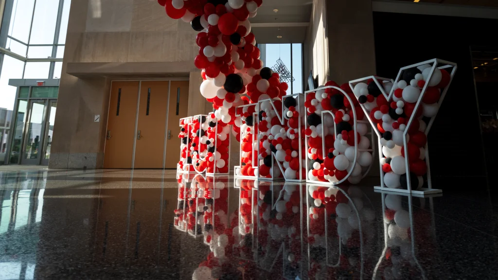A red and white balloon letter sculpture of IU Indy.