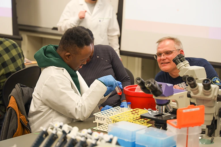 Two people working together at lab table