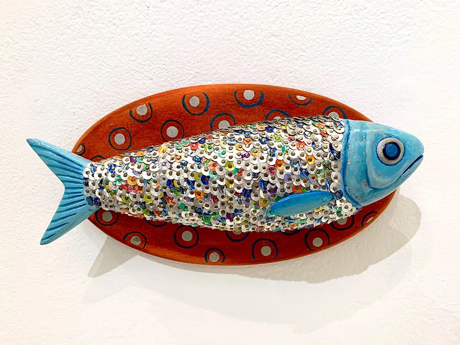 Colorful sculpture of mounted fish covered in sequins