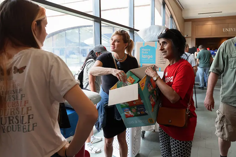 Chancellor Ramchand handing out chip bags to students