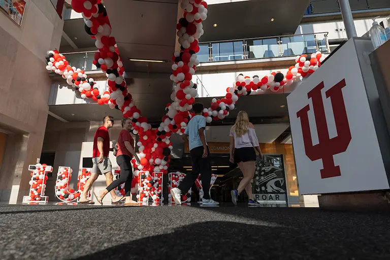 Students walking through an IU Indianapolis building decorated with balloons