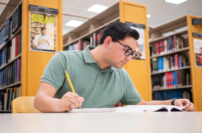 A student doing homework in a library