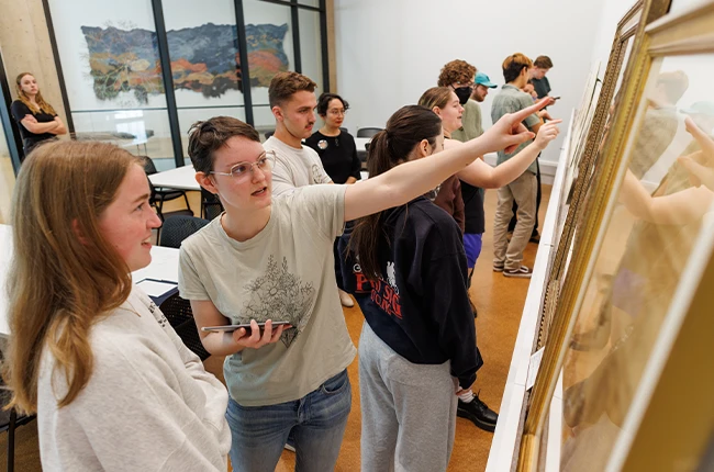 Students discussing items in a museum