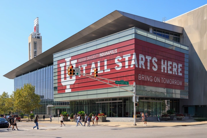 A busy summer day on campus as crowds of students walk by the campus center.