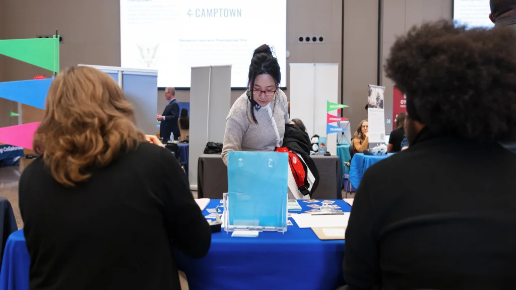 A female student in professional attire looking over materials at a student employment fair at IU Indianapolis.