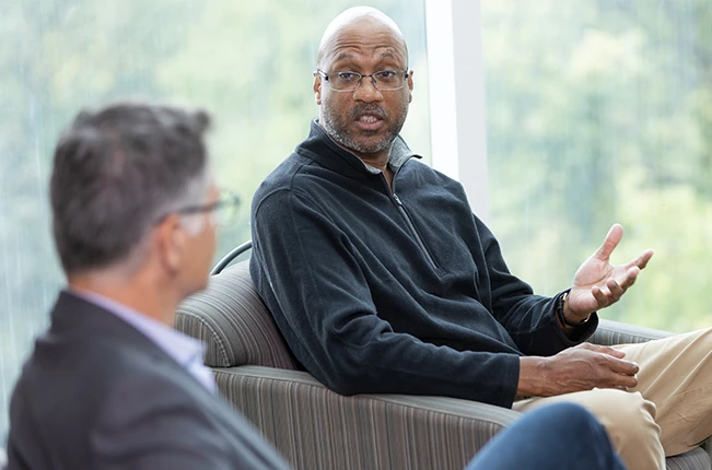 Two people sitting and talking