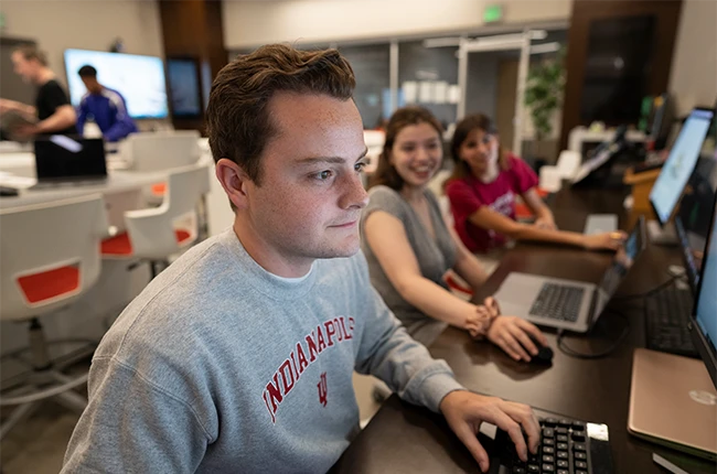A group of people looking at computer screens
