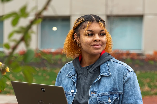 Student sitting outside on campus.