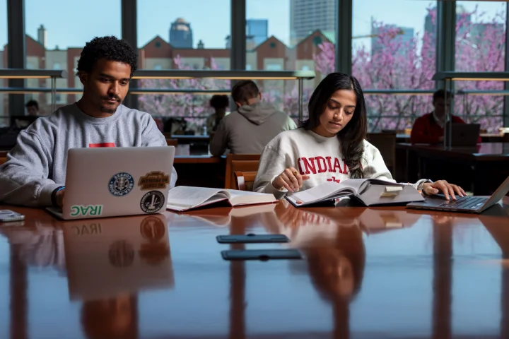 Two students studying at one of Indiana University Indianapolis' libraries.
